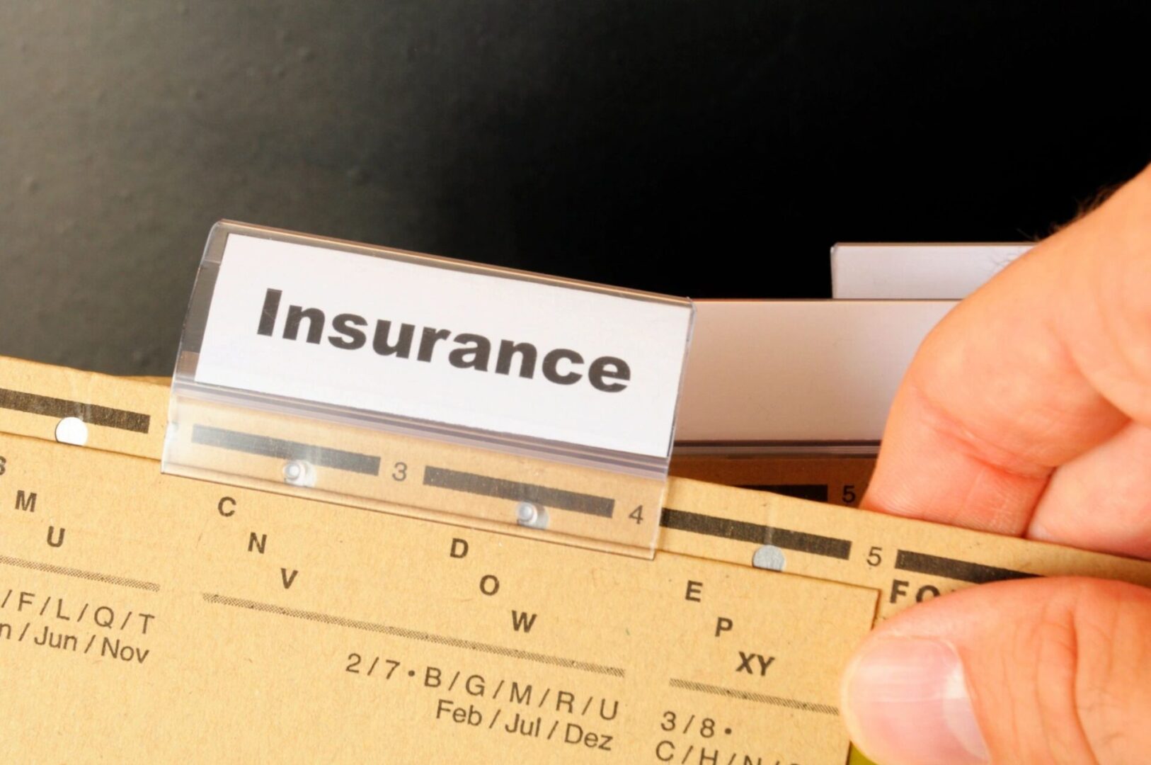 A person holding an insurance card in their hand.